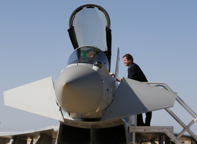 File photo of Prime Minister David Cameron speaks to an airman in the cockpit of a Typhoon fighter jet.