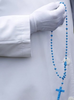 A nun holds Rosary beads at a procession in Knock last May