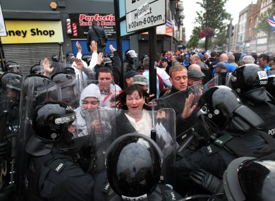 Police clash with loyalist protestors in Belfast city centre as they attempted to block part of the route the Anti-Internment League parade.