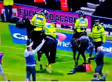 A police horse tramples on a steward.