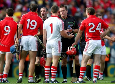 Question time: Cork's players speak to referee Brian Gavin at the final whistle.