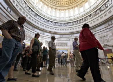 With hours to go until a possible government shutdown, visitors tour the Rotunda of the Capitol in Washington DC.