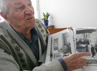 Rochus Misch, pictured in 2005, points to a picture of Adolf Hitler from the early 1940s.