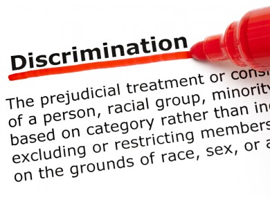 Definition of the word Discrimination underlined with red marker on white paper.