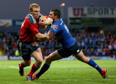 Munster's Keith Earls beats the tackle of Rob Kearney of Leinster on his way to scoring the first try of the game.