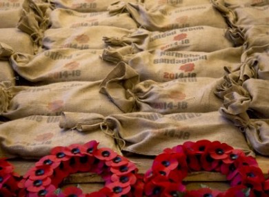 Sandbags, filled with soil from the World War I battlefields of Flanders, are piled next to poppy wreaths at the In Flanders Fields Museum in Ypres, Belgium.