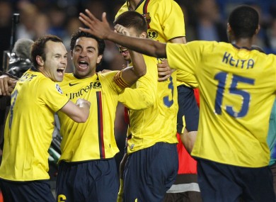 Barcelona's Andres Iniesta, left, celebrates with his Barca teammates in 2009.