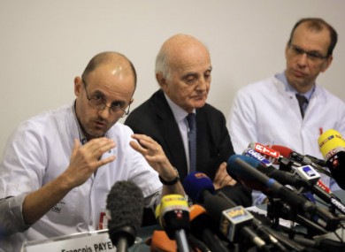 Professor Jean-Francois Payen, left, as two other doctors look on during a press conference at the Grenoble hospital.