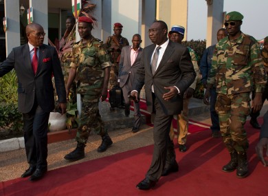 Michel Djotodia (centre) walks to board his plane to Chad on Wednesday.