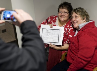 Cheryl Haws, right, and her partner Shelly Eyre have their photograph taken after receiving their marriage license at the Utah County Clerk's office in Provo, Utah