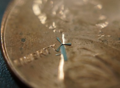 One of the micro-windmills resting on top of a US penny.