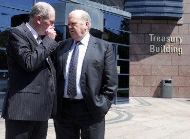 NTMA Chief Executive John Corrigan (left) and Minister for Finance Michael Noonan TD speak outside Treasury Building.