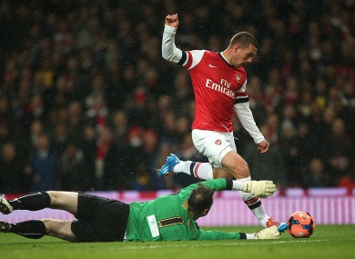 Arsenal's Lukas Podolski goes round Coventry City goalkeeper Joe Murphy to score his side's first goal of the game.