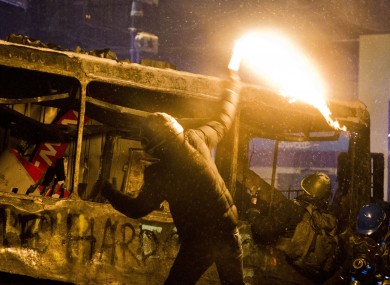 A protester throws a Molotov cocktail during clashes with police in central Kiev.