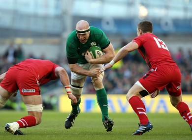 Paul O'Connell charges at Dan Lydiate and Scott Williams of Wales.