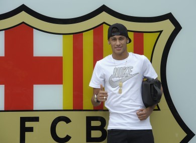 FC Barcelona's then new signing Neymar gestures upon his arrival at the club's office at the Camp Nou stadium in Barcelona, Spain. A Spanish court has charged Spanish league champion Barcelona with tax fraud of € 9.1m over the transfer of the Brazil star.