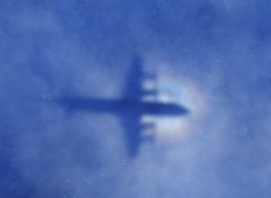 A shadow of a New Zealand Air Force aircraft is seen on low cloud cover while it searches for MH370.