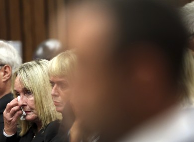 June Steenkamp, the mother of Reeva Steenkamp, left, wipes her face with a tissue at the start the trial of Oscar Pistorius at the high court in Pretoria.