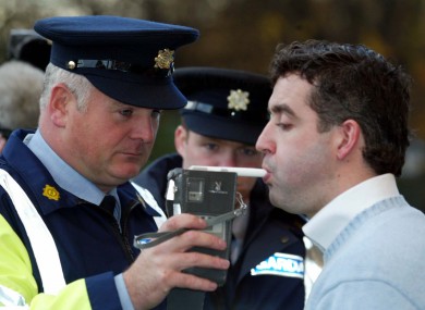 An actor is breathalysed during a mock drink driving test.