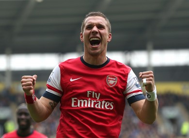 Arsenal's Lukas Podolski celebrates scoring his side's third goal.