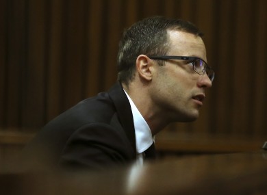 Oscar Pistorius sits in the dock at a court in Pretoria, South Africa