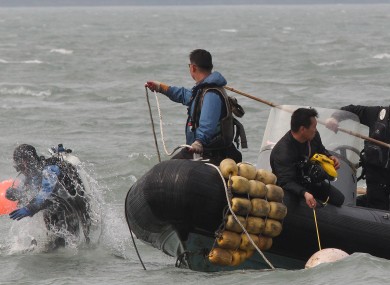 A South Korean frogman dives into a water search passengers believed to have been trapped in the sunken ferry Sewol in the water off the southern coast near Jindo.