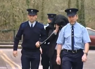 McGrath being led away from court during the murder case of Sylvia Roche Kelly.