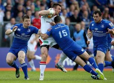 Rob Kearney halts the run of Ulster's Tommy Bowe.