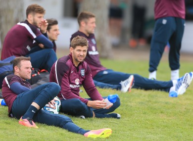 England captain Steven Gerrard talks with Wayne Rooney at the Vale Do Lobo Resort after training.