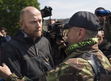 The head of foreign military observers, German Col. Axel Schneider, left, embraces Vacheslav Ponomarev, the self-proclaimed mayor of Slovyansk, after he has been feed in Slovyansk.