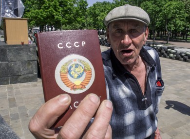 An elderly man brandishes his passport, ahead of the regional referendum in the eastern Ukraine city of Luhansk.
