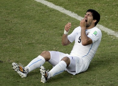Toothache: Suarez reacts to that clash with Chiellini.