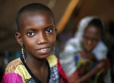 10-year-old Hamamatou Harouna smiles as she sits in a tent with other Muslim refugees on the grounds of the Catholic Church in Carnot, Central African Republic.