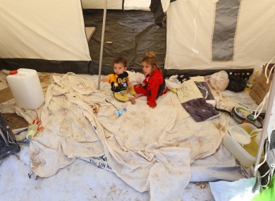 Iraqi children who have fled fighting between security forces and al-Qaida inspired militants in their hometown of Tal Afar carry sit in a tent at Germawa camp for displaced Iraqis.
