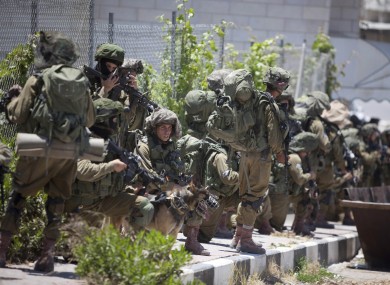 Israeli soldiers patrol during a military operation to search for three missing teenagers outside the West Bank city of Hebron.