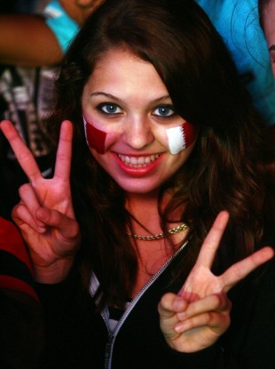 A woman celebrates the awarding of the 2022 World Cup to Qatar in 2010.