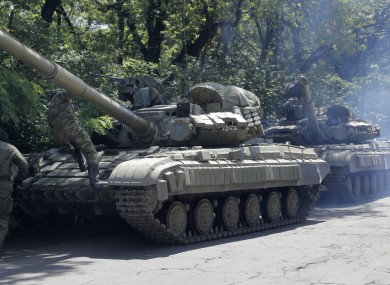 Pro-russian troops prepare to travel in a tank on a road near the town of Yanakiyevo, Donetsk region, eastern Ukraine.
