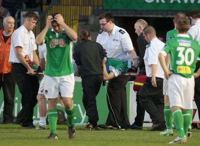 Cork City's Brian Lenihan is taken off injured after a bad fall at Dalymount Park.