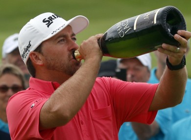 Graeme McDowell drinks champagne after winning the French Open Golf tournament at Paris National course.