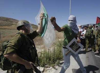 A Palestinian confronts an Israeli soldier, left, during a demonstration near the West Bank town of Nablus.