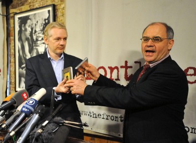 File photo dated 17 January 2011: Rudolf Elmer hands two CDs to WikiLeaks founder Julian Assange.