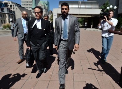 Khurram Syed Sher (centre) leaves court today after being found not guilty.