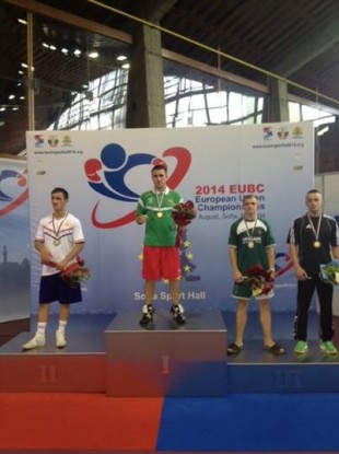 David Joyce wears his gold medal on the podium.