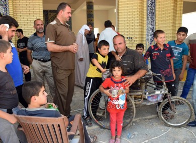 Displaced Iraqis wait for relief aid at a mosque on the outskirts of Irbil, northern Iraq, last week.