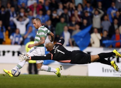 Celtic's Anthony Stokes scores with St Johnstone's Alan Mannus (right) during the Scottish Premier League match at McDiarmid Park, Perth.