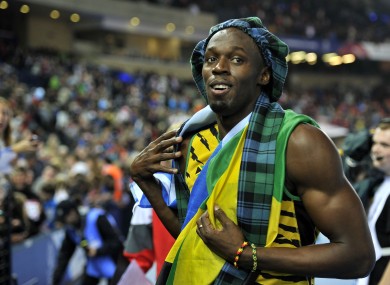 Jamaica's Usain Bolt wears tartan as he celebrates after winning the Men's 4x100m Relay at Hampden Park.