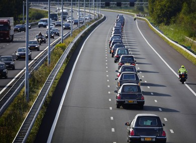 A convoy of hearses bearing the remains of passengers and crew killed in the downing of Malaysia Airlines Flight 17 makes its way along a highway near Boxtel, Netherlands.