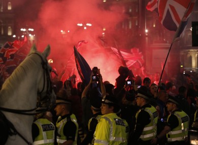 Police stand in front of Unionists gathered in George Square, Glasgow last night.