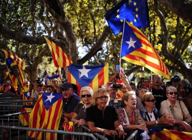 People wave 'estelada' flags, that symbolize Catalonia's independence, during a demonstration calling for the independence of Catalonia.
