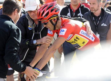Alberto Contador of Spain is helped after winning the 20th stage of the Vuelta.